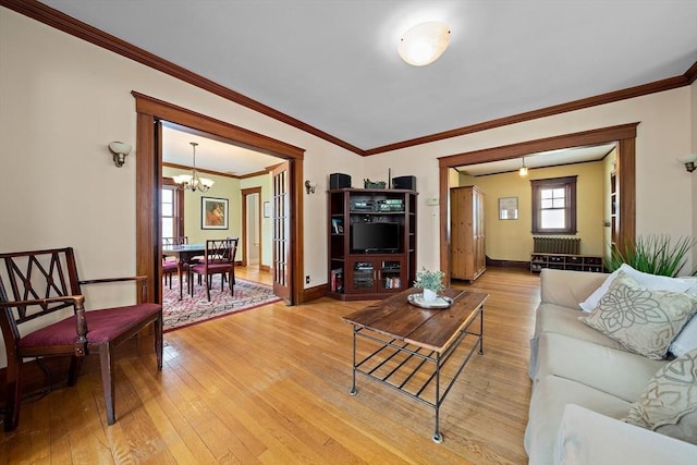 149 Milton Ave, Boston, MA 02124 - living area featuring a chandelier, light wood-style flooring, ornamental molding, and baseboards