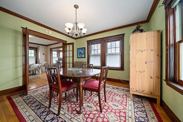 149 Milton Ave, Boston, MA 02124 - dining area with light wood-style floors, ornamental molding, a chandelier, and baseboards
