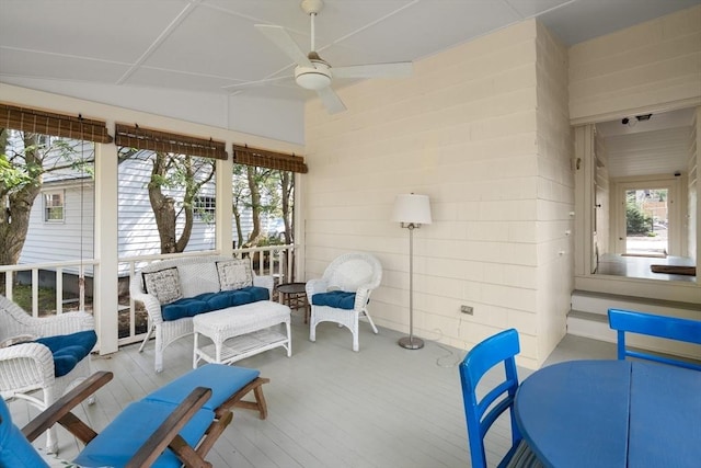 sunroom featuring a healthy amount of sunlight and ceiling fan