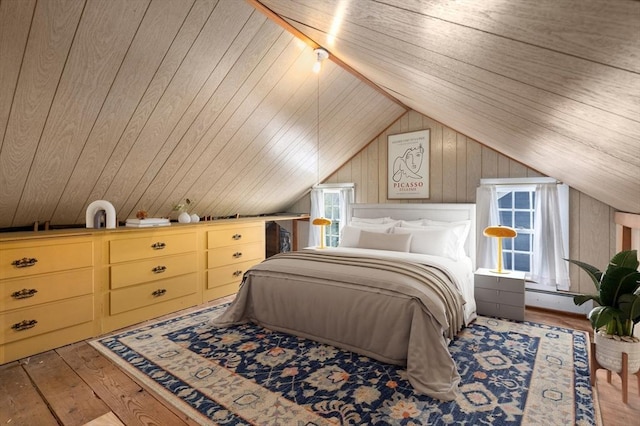 bedroom with wooden walls, vaulted ceiling, and wood finished floors