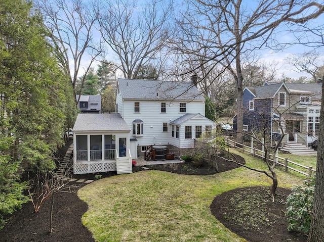 back of property featuring fence, a chimney, a sunroom, central AC unit, and a yard