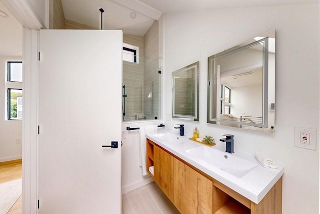 133 Charles St Unit 133, Cambridge, MA 02141 - bathroom with double vanity, a tile shower, and wood finished floors