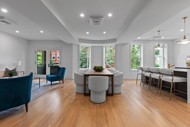 dining space with light hardwood / wood-style flooring and plenty of natural light