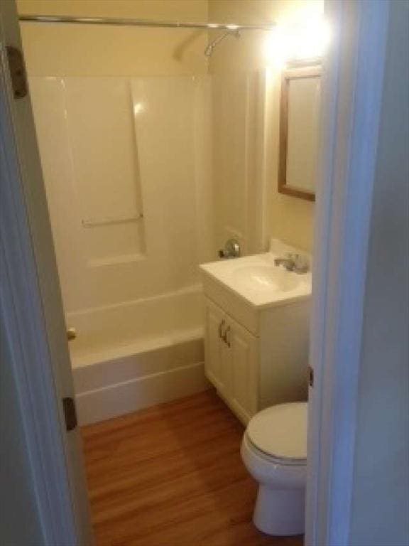 full bathroom featuring toilet, vanity, tub / shower combination, and hardwood / wood-style flooring