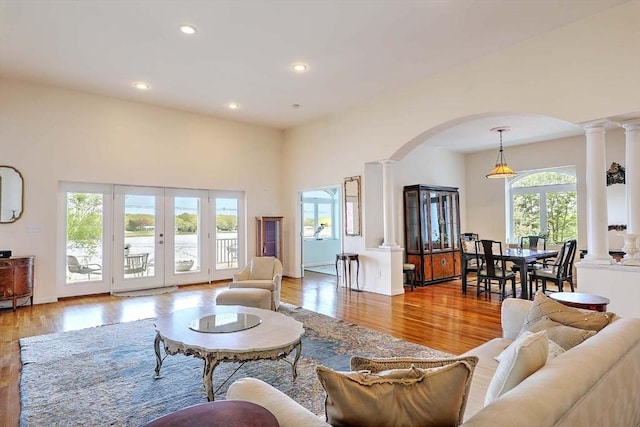2386 Pleasant, Dighton, MA 02715 - living room featuring ornate columns, arched walkways, wood finished floors, recessed lighting, and a towering ceiling