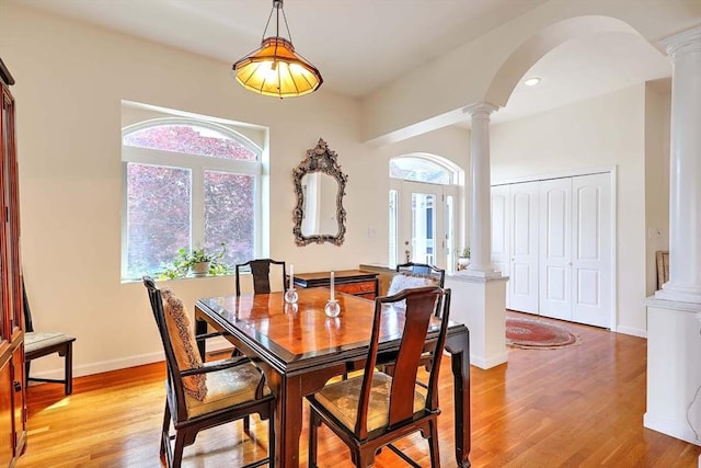 2386 Pleasant, Dighton, MA 02715 - dining room with decorative columns, light wood-type flooring, arched walkways, and baseboards