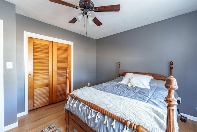 bedroom with a closet, ceiling fan, and light wood-type flooring