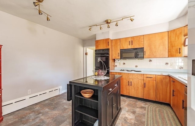 kitchen featuring track lighting, decorative backsplash, baseboard heating, and black appliances