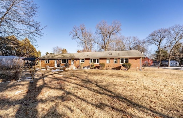 rear view of house featuring a lawn