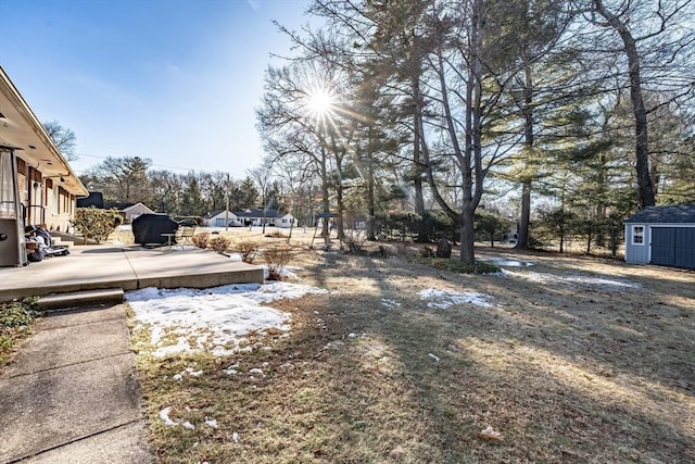 view of yard featuring a wooden deck and a shed