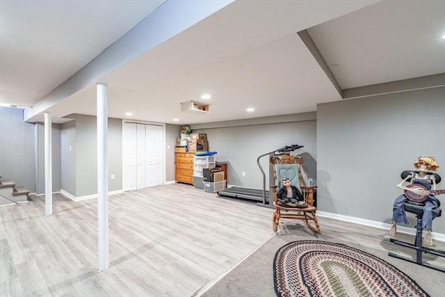 workout room featuring light wood-type flooring