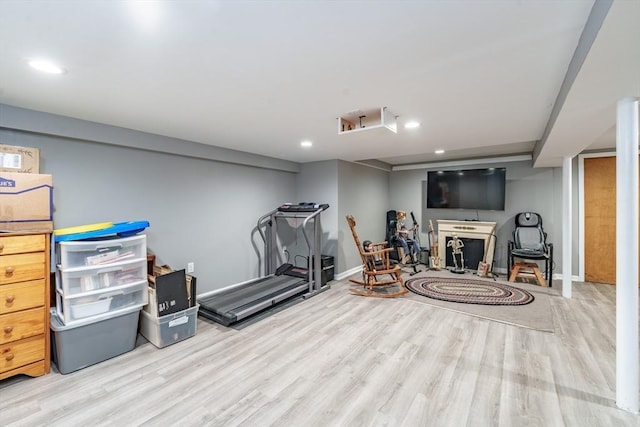 exercise room with light hardwood / wood-style floors