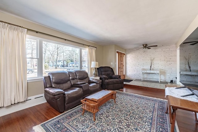 living room featuring dark hardwood / wood-style floors, ceiling fan, and a wood stove