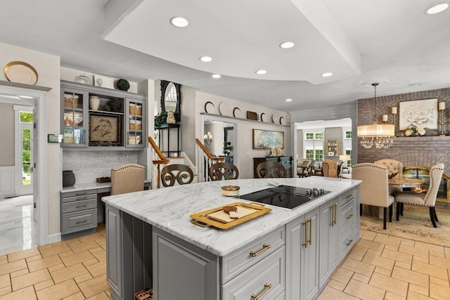 8 Riverside Ter, Easton, MA 02356 - kitchen featuring gray cabinetry, black electric stovetop, recessed lighting, glass insert cabinets, and a center island