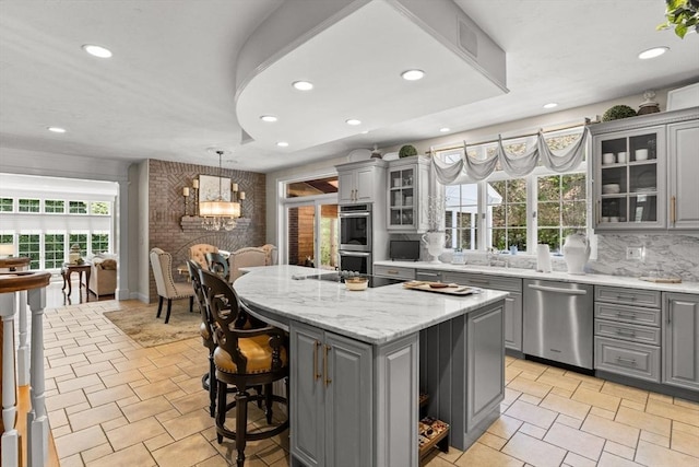 8 Riverside Ter, Easton, MA 02356 - kitchen featuring gray cabinetry, appliances with stainless steel finishes, a kitchen island, recessed lighting, and decorative backsplash