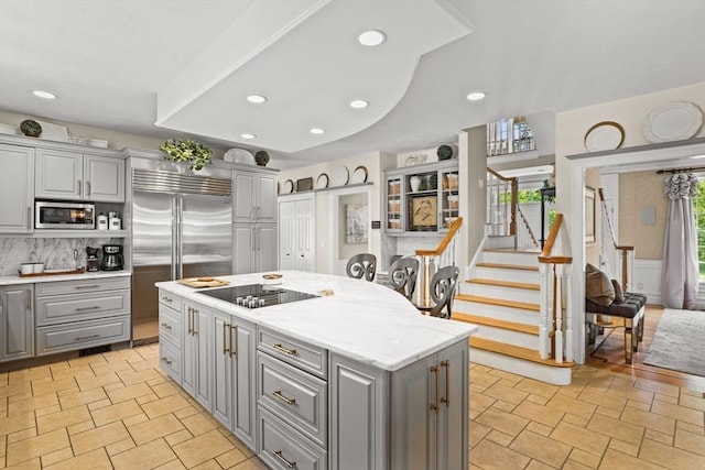 8 Riverside Ter, Easton, MA 02356 - kitchen with gray cabinets, built in appliances, a center island, decorative backsplash, and recessed lighting