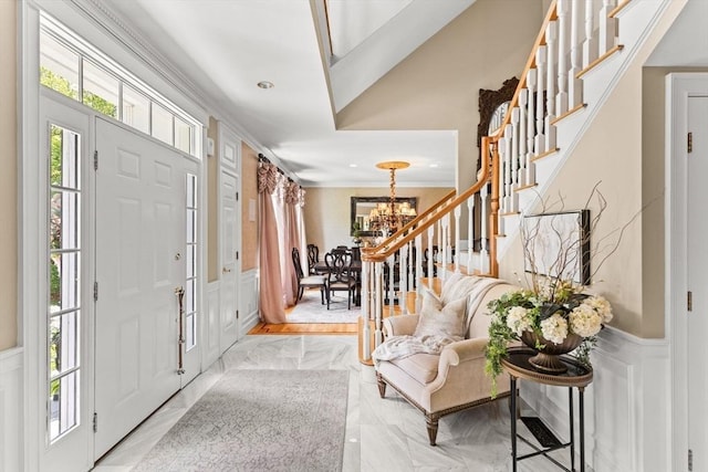 8 Riverside Ter, Easton, MA 02356 - entrance foyer with a decorative wall, a wainscoted wall, stairs, a chandelier, and ornamental molding