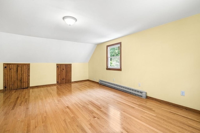 98 G St, Dracut, MA 01826 - additional living space featuring baseboard heating, light wood-style floors, lofted ceiling, and baseboards
