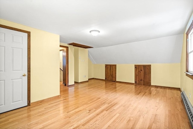 98 G St, Dracut, MA 01826 - bonus room with a baseboard heating unit, light wood-style flooring, lofted ceiling, and baseboards