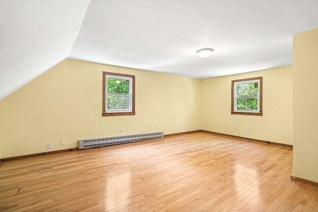 98 G St, Dracut, MA 01826 - unfurnished room with baseboard heating, plenty of natural light, hardwood / wood-style flooring, vaulted ceiling, and baseboards