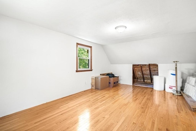 98 G St, Dracut, MA 01826 - additional living space with light wood-style flooring, water heater, and vaulted ceiling