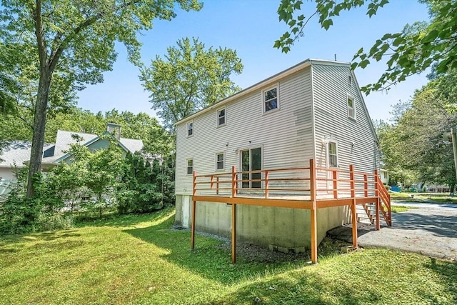 98 G St, Dracut, MA 01826 - back of property with a yard and a wooden deck