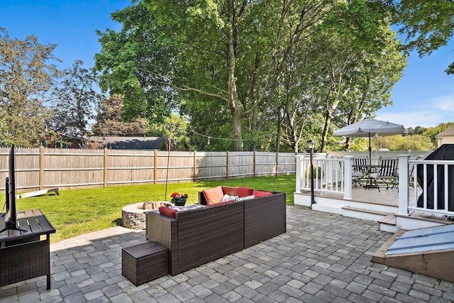 view of patio with an outdoor living space and a grill