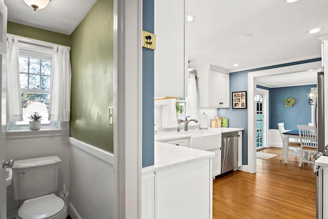 bathroom featuring toilet, wood finished floors, recessed lighting, and vanity