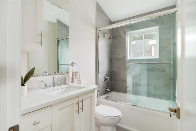 full bath with toilet, vanity, and enclosed tub / shower combo