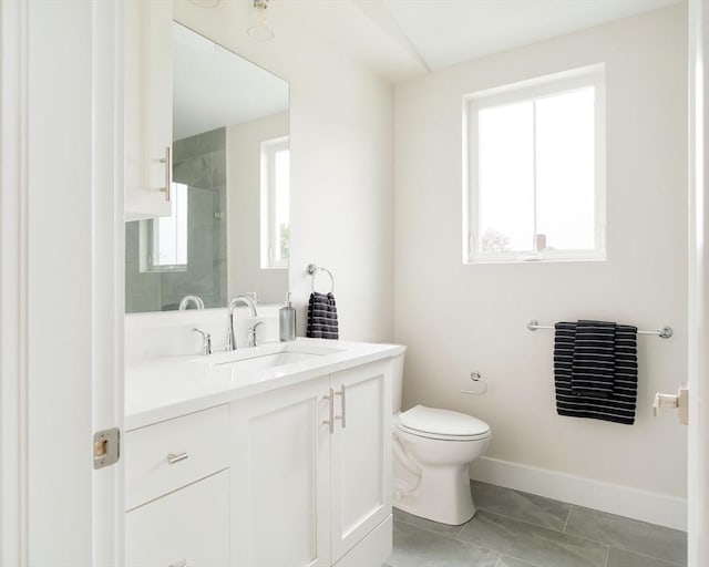 bathroom featuring toilet, tiled shower, vanity, baseboards, and marble look tile flooring