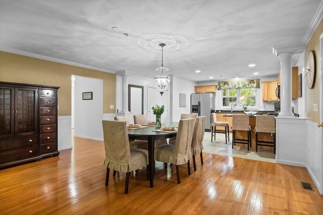 18 Dale St Unit 7A, Andover, MA 01810 - dining area featuring decorative columns, light wood-type flooring, a chandelier, crown molding, and recessed lighting