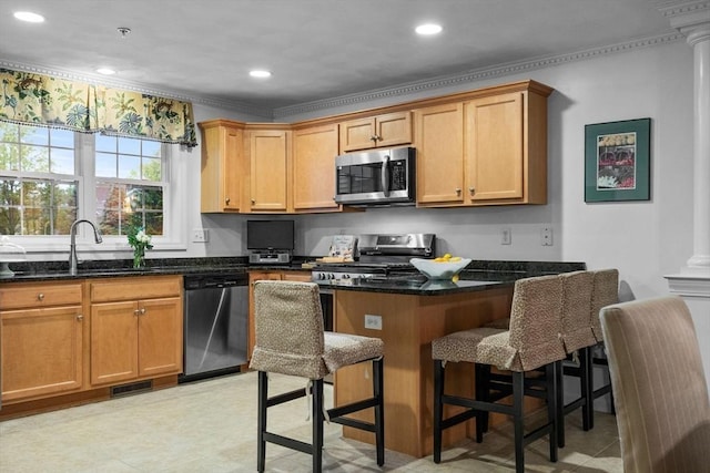 18 Dale St Unit 7A, Andover, MA 01810 - kitchen with appliances with stainless steel finishes, a sink, ornamental molding, dark stone countertops, and a kitchen breakfast bar
