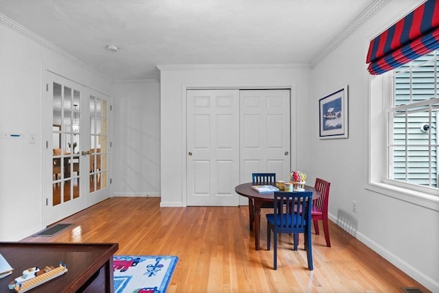 18 Dale St Unit 7A, Andover, MA 01810 - dining area featuring french doors, light wood finished floors, baseboards, and ornamental molding