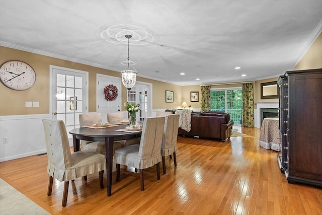 18 Dale St Unit 7A, Andover, MA 01810 - dining space featuring light wood-style flooring, crown molding, recessed lighting, and a fireplace