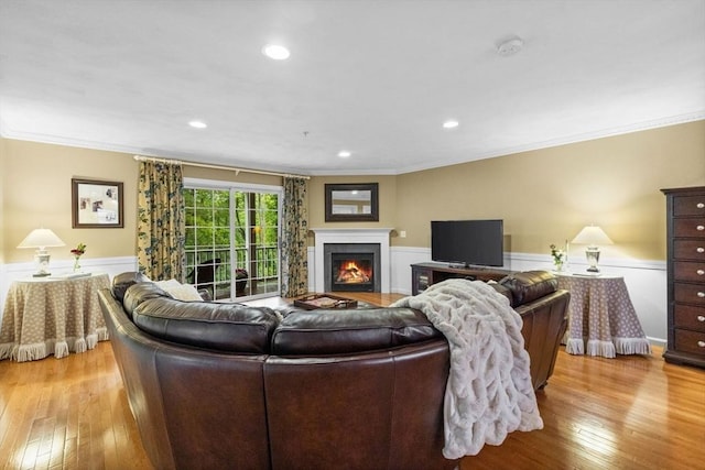 18 Dale St Unit 7A, Andover, MA 01810 - living room with light wood-style flooring, wainscoting, crown molding, a lit fireplace, and recessed lighting