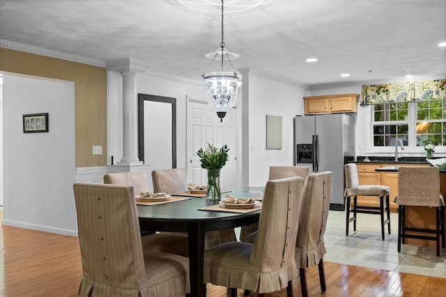 18 Dale St Unit 7A, Andover, MA 01810 - dining area with ornate columns, crown molding, light wood finished floors, a chandelier, and recessed lighting