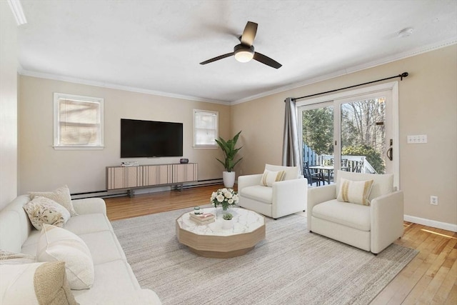 living room featuring a ceiling fan, wood-type flooring, crown molding, and baseboards