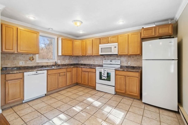 kitchen with white appliances, dark countertops, a sink, and crown molding