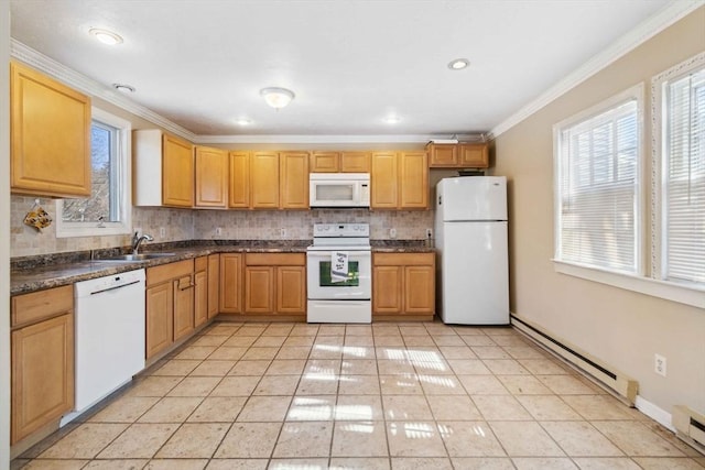 kitchen with light tile patterned floors, dark countertops, baseboard heating, a sink, and white appliances