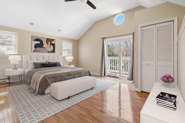 bedroom featuring baseboards, a ceiling fan, wood-type flooring, access to outside, and vaulted ceiling