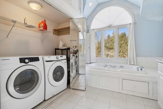 laundry room with light tile patterned floors, laundry area, and washer and dryer