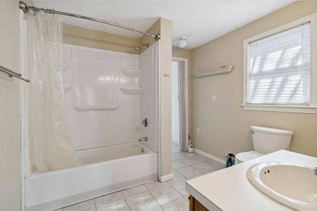 bathroom featuring tile patterned flooring, toilet, vanity, baseboards, and shower / bath combo