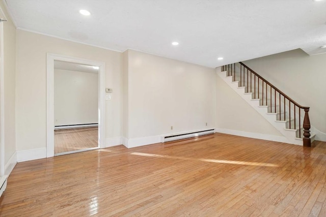 unfurnished living room with hardwood / wood-style flooring, recessed lighting, baseboards, stairs, and baseboard heating