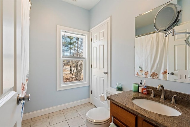 bathroom featuring tile patterned flooring, toilet, vanity, and baseboards