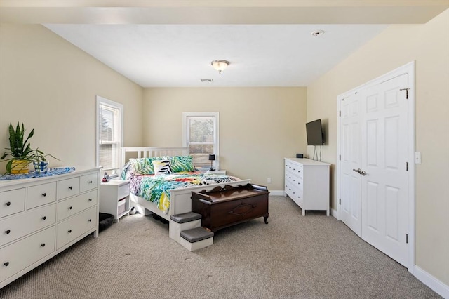 bedroom featuring baseboards and light colored carpet