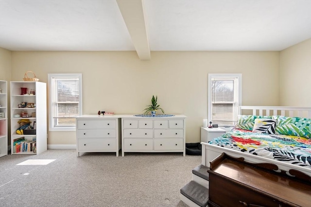 bedroom featuring beam ceiling and light colored carpet