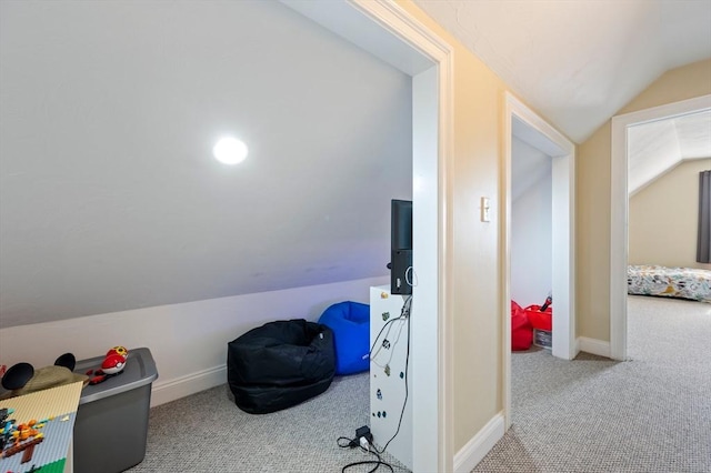 game room with carpet flooring, baseboards, and vaulted ceiling