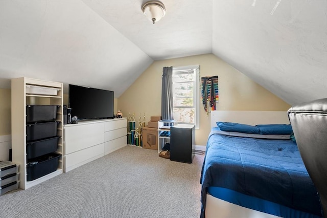 bedroom with carpet flooring and vaulted ceiling