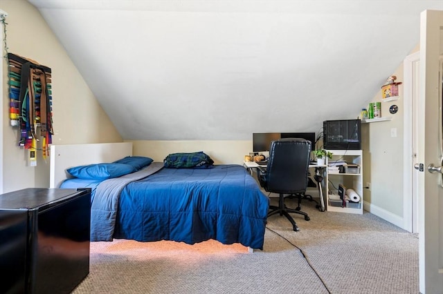 carpeted bedroom featuring lofted ceiling and baseboards