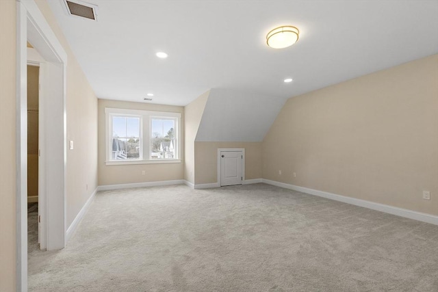 additional living space with visible vents, baseboards, carpet floors, recessed lighting, and vaulted ceiling